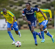 Mogarolodi Ngele of Bidvest Wits (C) move past Lucky Mohomi (R) and Anele Ngcongca of Mamelodi Sundowns during the Absa Premiership match at Bidvest Stadium on May 01, 2017 in Johannesburg, South Africa. Wits won 1-0.