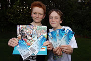 Logan Campbell, 8 (L) and brother Riley, 10, celebrate being the first people in the world to receive their Rugby World Cup tickets at their home on May 12, 2011 in Wellington, New Zealand. The 2011 RWC will be held in New Zealand from September 9 to October 23