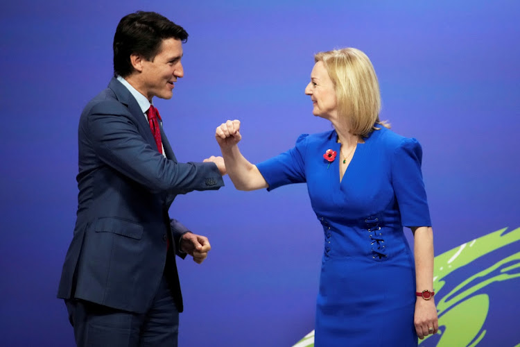 Britain's Foreign Minister Liz Truss greets Canada's Prime Minister Justin Trudeau at the UN Climate Change Conference (COP26) in Glasgow, Scotland, Britain, November 1, 2021.