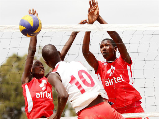 Teresa Akal (R) of Kwanthanze Sec School spikes against Lucy Sakong (L) and Edna Muombe of AIC Kosirai during their volleyball women’s final tie of the Kenya Secondary Schools Sports Association (KSSSA) Term 2B at Machakos Boys High School on August 1, 2015. / PIC CENTRE