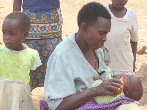 A woman feeds her child at an IDP camp in Nyimbei, Baringo South, which has been affected by bandits attacks, February 27, 2017. /JOSEPH KANGONGO