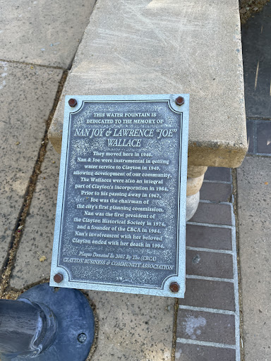 THIS WATER FOUNTAIN IS DEDICATED TO THE MEMORY OF NAN JOY& LAWRENCE "JOE" WALLACE They moved here in 1946. Nan & Joe were instrumental in getting water service to Clayton in 1949, allowing...