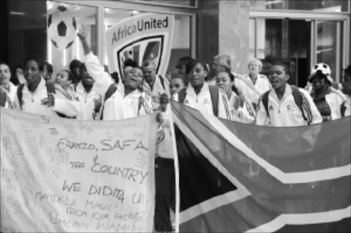 MAKING HISTORY: A jubilant women's Under-17 team arriving at the OR Tambo International Airport from Tunisia where they qualified for the World Cup to be held later this year in Trinidad and Tobago. Pic. BAFANA MAHLANGU. 31/05/2010. © Sowetan. 20100531 BMA A Jubilant woman U17 team arriving at the OR Tambo International Airport from Tunisia where they qualified for the World Cup later this year in Trinidad and Tobago. PHOTO: BAFANA MAHLANGU