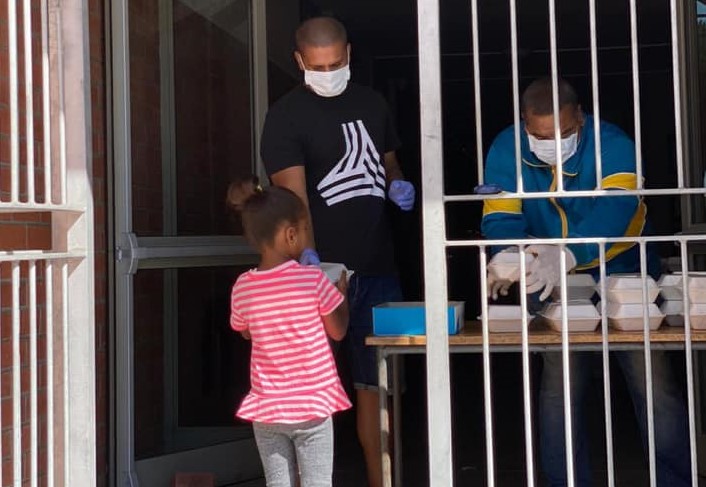 A girl receives a meal at her school on the first day of the Western Cape education department's Covid-19 feeding scheme on April 8 2020. A call has been made for the basic education department to revive the feeding scheme that provides meals to nine million school children. The scheme has not been operating since the closure of schools during lockdown.