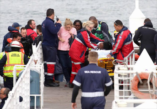 Rescue personnel and passengers from the Thandi after the ferry sank. Picture ESA ALEXANDER