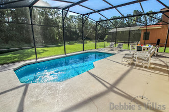 Sunny pool deck with woodland view on gated Davenport community of Watersong
