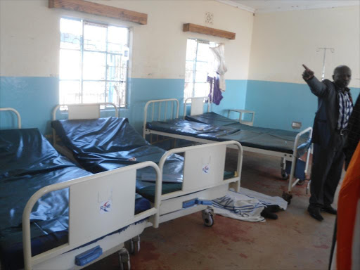 Mwingi surgical ward with empty beds and the lifeless body of the 26 year old Fredrick Ngandi who was shot six times in the day and later sprayed with bullets in Mwingi ward in his sisters’ presence. Photo by Lydia Ngoolo.