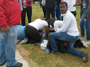 A woman‚ believed to be a staff member‚ collapsed after being teargassed. Picture: Siyamtanda Capa