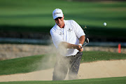 Wayne Westner of South Africa plays his third shot at the par 4, 14th hole during the first round of the 2014 Omega Dubai Desert Classic on the Majlis Course at the Emirates Golf Club on January 30, 2014 in Dubai, United Arab Emirates.
