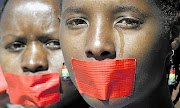 In this image, Nomsa Dladla and Dudu Muvhali had joined a protest to highlight how the  justice system is failing rape victims. The writer of this column states that in this country, rapists are given the benefit of the doubt and the victim has to prove that she was violated.