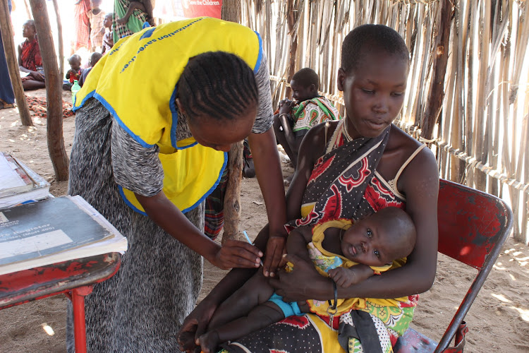 Health worker administering routine immunization program of under five years in Kerio, Turkana Central