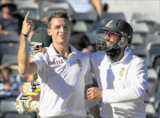 TEST CRICKET'S TOP FAST BOWLER: South Africa's Dale Steyn, left, is congratulated by teammate Hashim Amla after dismissing Australia's Nathan Lyon at the Waca during the fourth day's play of the third Test match in Perth on Monday . PHOTO: REUTERS