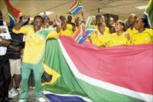 NO SHAME: These singing Bafana Bafana fans were at the airport to welcome the team home.Pic. Tshepo Kekana. 02/02/08. © Sowetan.