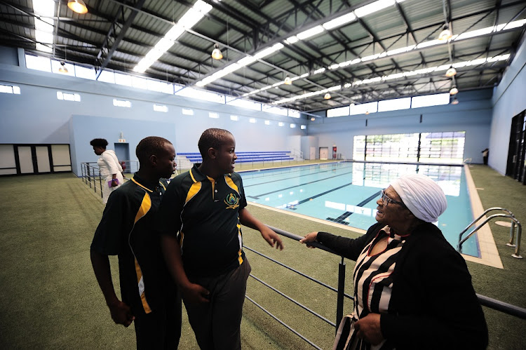 Gloria Hlatshwayo admires a swimming pool with two pupils at the Nokuthula LSEN School on October 17, 2017.