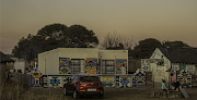 A homestead of the Msiza family, occupied by Siyabonga's grandmother, and the venue of the Wela homecoming celebration. In the old days, if you had a son at the Wela, you had to repaint your house (various muds created the different colours, but today they have been replaced by commercial paints). A white flag denotes the home of an initiate.