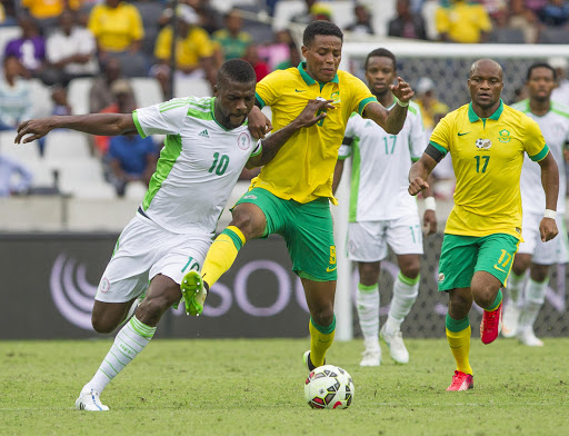 A file photo of Ogu John Ugochukwu (L) of Nigeria and Bongani Zungu (C) of Bafana Bafana as his teammate Tokelo Rantie (R) watches on during the International Friendly match between South Africa and Nigeria at Mbombela Stadium on March 29, 2015 in Nelspruit, South Africa.