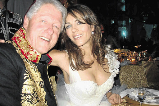 CLOSE BUT NO CIGAR: Bill Clinton and Liz Hurley at a charity dinner in Russia in 2005