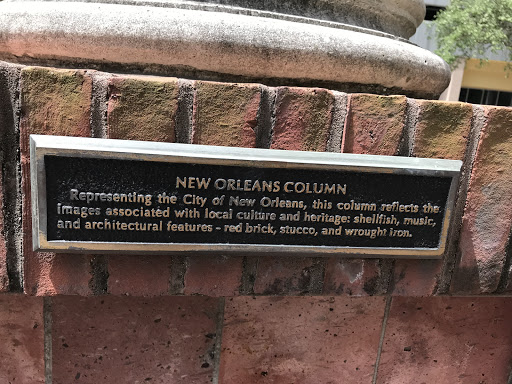 Representing the City of New Orleans, this column reflects the images associated with local culture and heritage: shellfish, music, and architectural features - red brick, stucco and wrought iron.