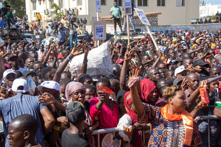 Azimio supporters wave placards during a rally in Mombasa on Sunday, March 12.