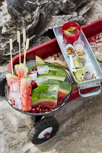 Watermelon with gin drizzle & spicy salts Nothing screams summer like cold watermelon on the beach. For a chefy twist, cut the fruit into lolly shapes and then dip it into a boozy syrup before coating it with Chilli lime or Cumin coriander salt.