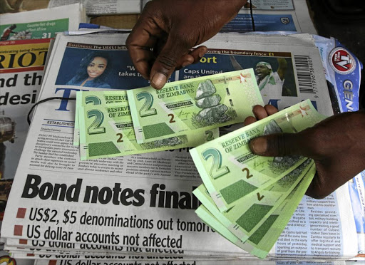 A street vendor with bond notes in Zimbabwe’s capital, Harare. Authorities have urged citizens to embrace the controversial currency.