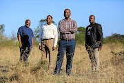 From left, Philasande Dotyeni, Themba Boqwana, Thando Wontoti and Buntu Nonkalela on the plot of land they secured an agreement to buy — a purchase funded by 200 buyers who put in R40,000 each — in East London in the Eastern Cape.