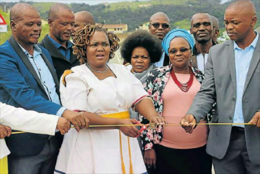 GETTING CONNECTED: Travelling for hours on a bumpy and dusty road to Isilimela Hospital in Port St Johns, is now a thing of the past, after the department of roads and public works built a R244-million road and two bridges. Seen here are members of the department at the ribbon-cutting ceremony yesterday Picture: SUPPLIED