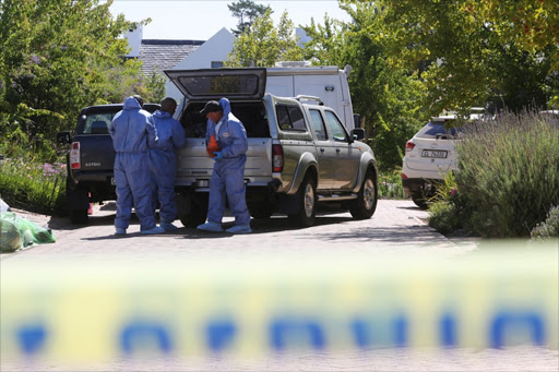 Forensic officers take cones out of a vehicle during a murder investigation. Martin, his wife Teresa and their 22-year-old son Rudi were murdered in their upmarket home on De Zalze Winelands Golf Estate in Stellenbosch yesterday.