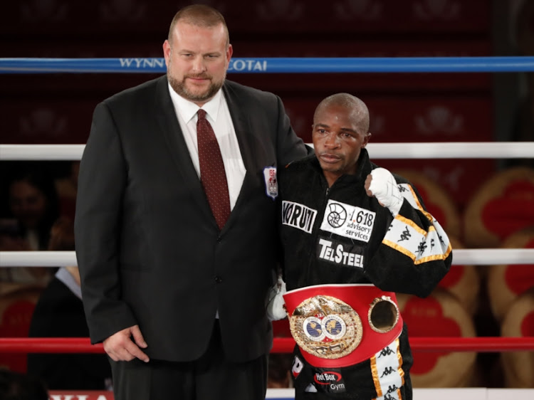 Moruti Mthalane of South Africa poses for a picture after defeating Masahiro Sakamoto of Japan in IBF Flyweight title bout.