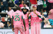 South Africa players Kagiso Rabada (L), Hashim Amla (C) and Aiden Markram (R) celebrate after dismissing Hardik Padya of India during the 2018 Momentum 4th ODI International Series match between the Proteas and India at Wanderers Stadium, Johannesburg South Africa on 10 February 2018.