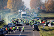 People wearing yellow vests, a symbol of a French drivers' nationwide protest against higher fuel prices, block the Paris-Brussels motorway in Haulchin, France, November 17, 2018. 
