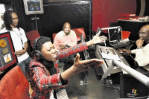 HONOURED: Lira is overcome with emotions at Kaya FM studios. With her are the station's MD Greg Maloka and T-Bose. Pic: Antonio Muchave. 04/06/2009. © Sowetan