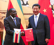 Zimbabwean President Robert Mugabe (L) and his Chinese counterpart Xi Jinping participate in a signing ceremony at the Great Hall of the People (GHOP). Photo credit: Getty images