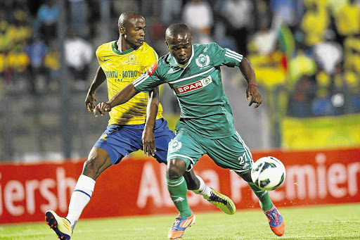 Mamelodi Sundowns' Teboho Langerman loses possession to Andile Khumalo of AmaZulu during their Premiership encounter at Lucas Moripe stadium in Atteridgeville last night. The game ended in a 1-1 Picture: SYDNEY SESHIBEDI