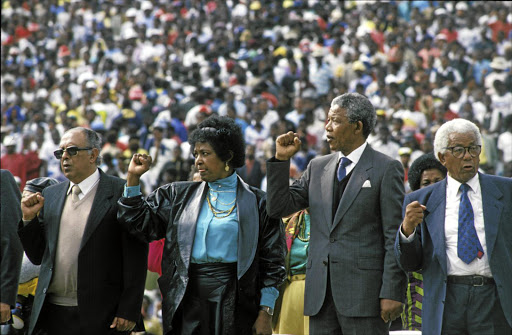 Ahmed Kathrada, Winnie Mandela, Nelson Mandela and Walter Sisulu at an ANC welcome rally at the FNB Stadium in Soweto in 1990.