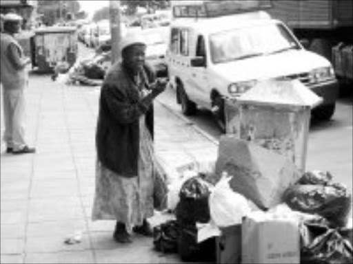 SEARCHING: Losihlahla Ndlela looks for useable items among the rubbish. Pic. Riot Hlatshwayo. 05/12/2006. © Sowetan.