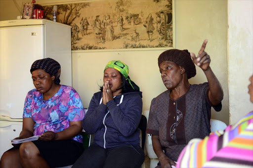 Dipuo Mosweu, Kopano Leteane's mother Ouma Mosweu and Martha Mosweu speaking to the Sowetan at their home in Coligny. Kopano Leteane is one of the victims who went missing and later found dead at a farm in Rietvlei last year match. Photo: Tiro Ramatlhatse