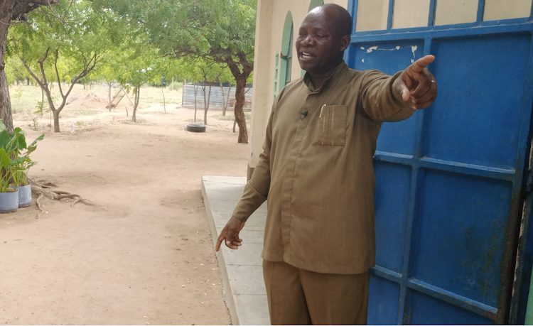 Reverend Joseph Mutunga of AIC church in Garissa points to the gate that militants used to access the church compound during the 2012 terror attack that left 20 people dead and several others injured