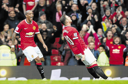 STAND-UP GUY: Wayne Rooney celebrates with Ashley Young after he scored Manchester United's third goal yesterday