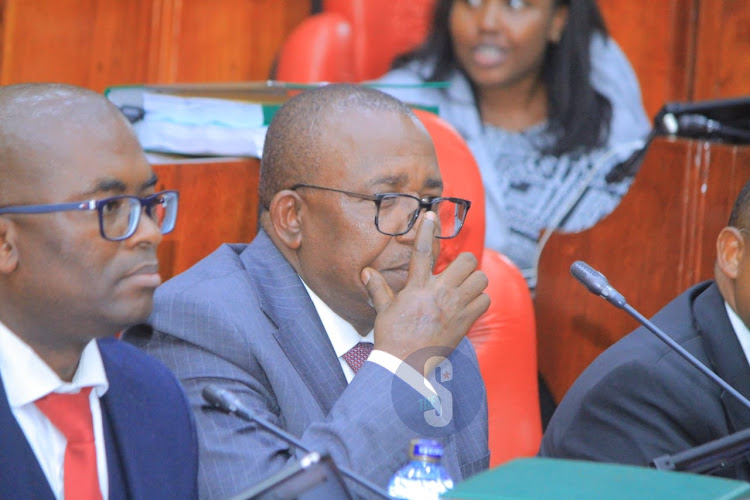 Agriculture Cabinet Secretary Mithika Linturi adjusts his spectacles as he follows pre-trial impeachment proceedings by the National Assembly select committee at County Hall on May 7, 2024.