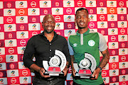 Coach Stephen Komphela and defender  Alfred Ndengane, both of Bloemfontein Celtic, showing off their gongs.