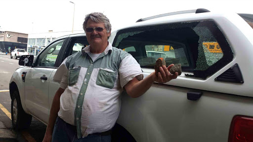 SORRY TALE: East London motorist Rodney Sparg stands next to his Ford Ranger, allegedly damaged by protesting students in Currie Street in Quigney on Monday night Picture: ZISANDA NKONKOBE