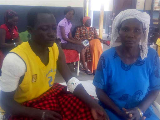 Emmanuel Erukudi, a form one student of Lokichogio Mixed Secondary School in Turkana county at Lodwar referral hospital with his aunt Rose Atyang , October 16,2017. /HESBOUN ETYANG
