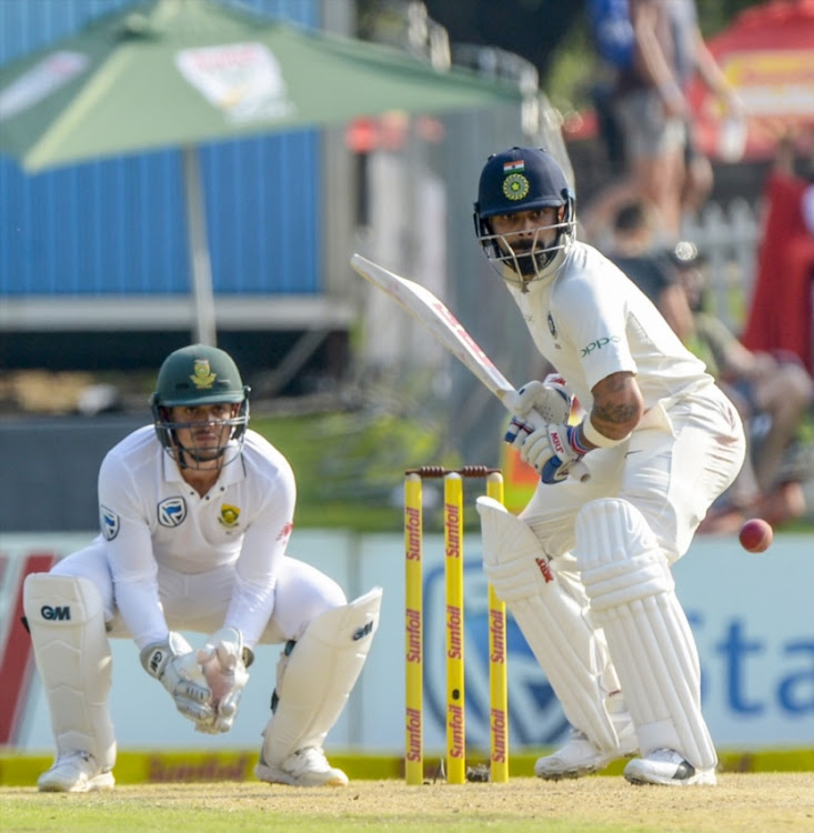 Captain Virat Kohli of India and wicketkeeper Quinton de Kock of South Africa during day 2 of the 2nd Sunfoil Test match between South Africa and India at SuperSport Park on January 14, 2018 in Pretoria.