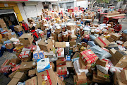 Employees sort boxes and parcels at a JD.com logistics station in Xi'an, Shaanxi province, China, after the Singles' Day online shopping festival.  