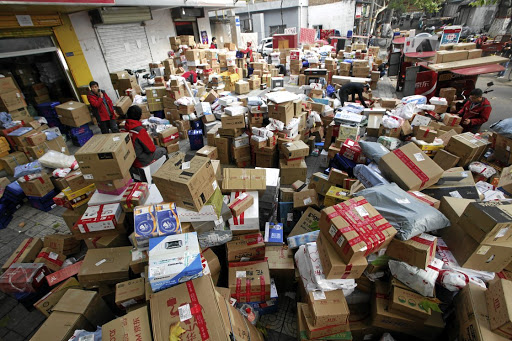Employees sort boxes and parcels at a JD.com logistics station in Xi'an, Shaanxi province, China, after the Singles' Day online shopping festival.