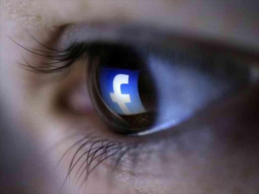 A picture illustration shows a Facebook logo reflected in a person's eye. /REUTERS
