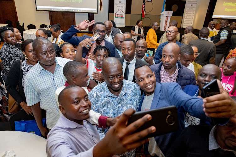 Deputy President Rigathi Gachagua taking photos with Kenyans Diaspora in Kigali, Rwanda on April 6, 2024