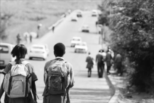 DANGER: Schoolchildren walk on the stretch of road between Protea North and Protea Glen where the four pupils were killed on Monday. Pic: BAFANA MAHLANGU. 10/03/2010. © Sowetan.