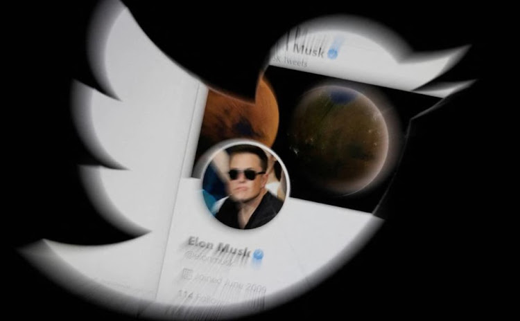 Elon Musk twitter account is seen through Twitter logo in this illustration taken, April 25, 2022.